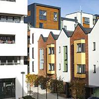 a row of houses with white and brick exteriors