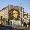 Mural of a girls face painted on the side of a building