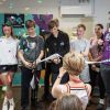 Young people opening the Youth Zone by cutting a ribbon
