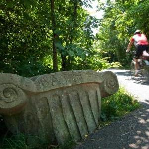 Image depicting a cycle path with a cyclist on it and a small pillar saying 'Bath 3 miles