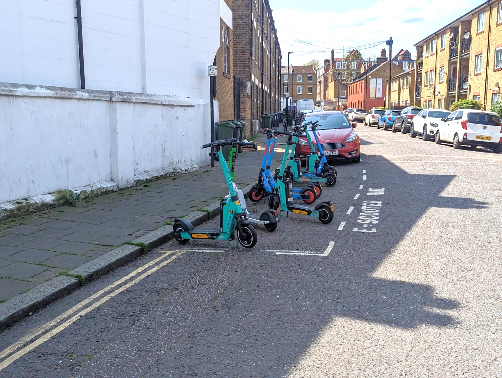 Illustrative image of a parking area for e-scooters. This is fully described in the text above.