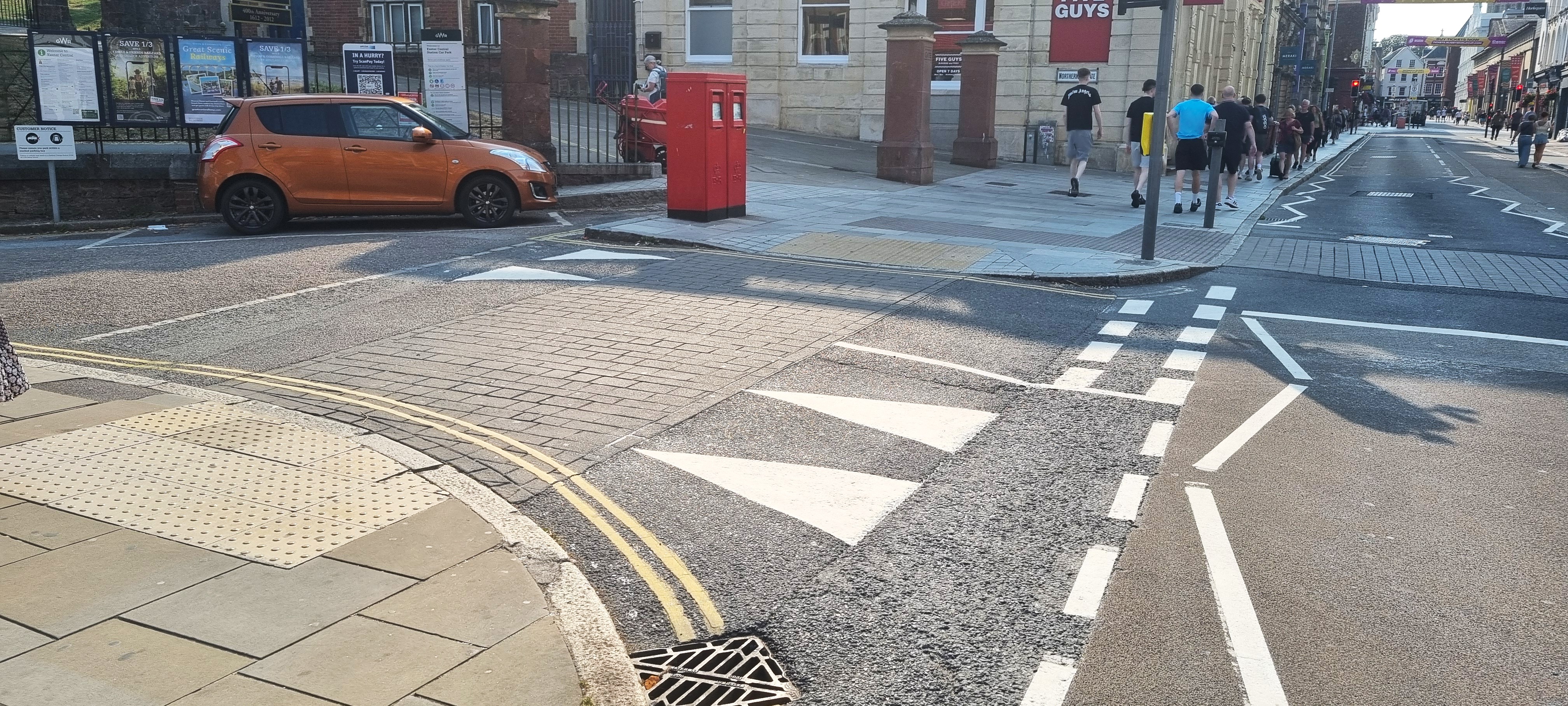 Illustrative image showing side-road junction improvements with the road narrowed and raised to pavement level. This is fully described in the text above.