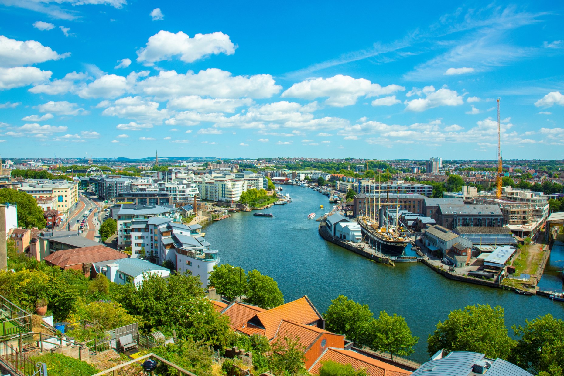 A birds eye view of the harbour, blue skies, buildings either side of the water