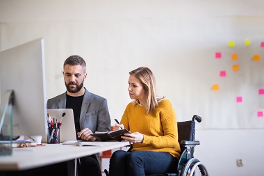 Two people working at a desk.