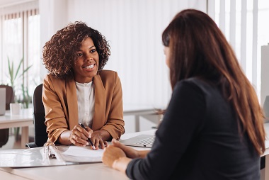 Two women in an office meeting.