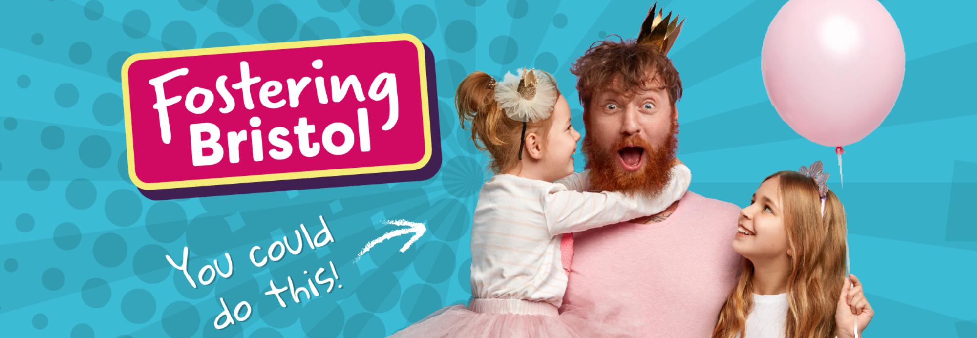 An adult man hugging two young girls, one of the girls is holding a balloon