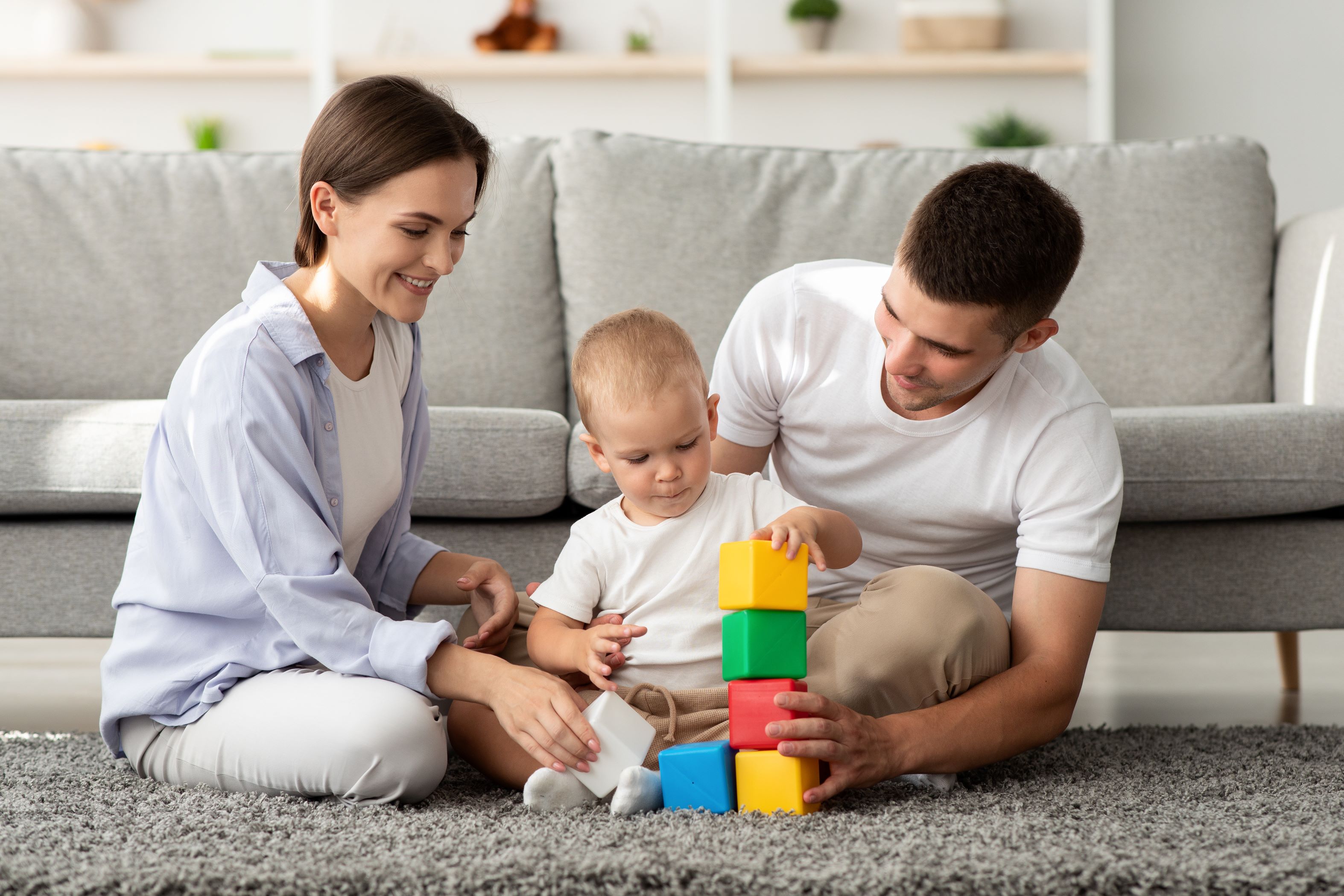 Man and woman playing with toddler