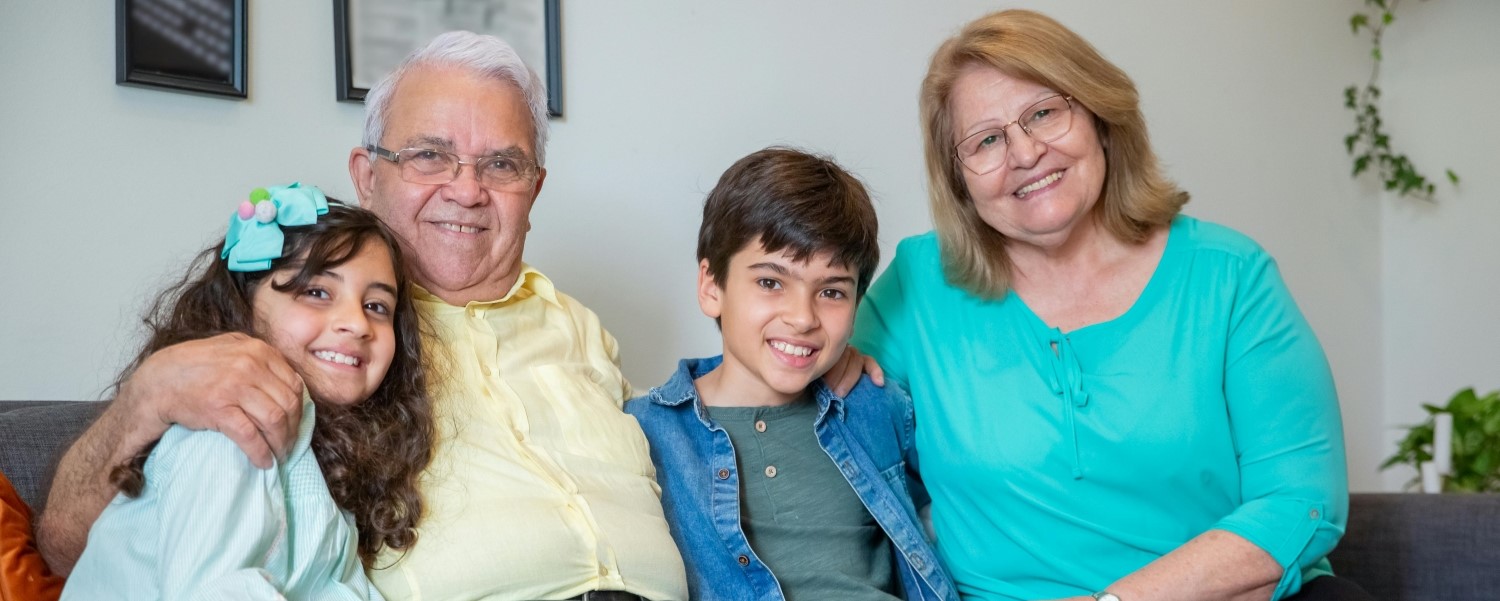Man, woman, young boy and young girl smiling