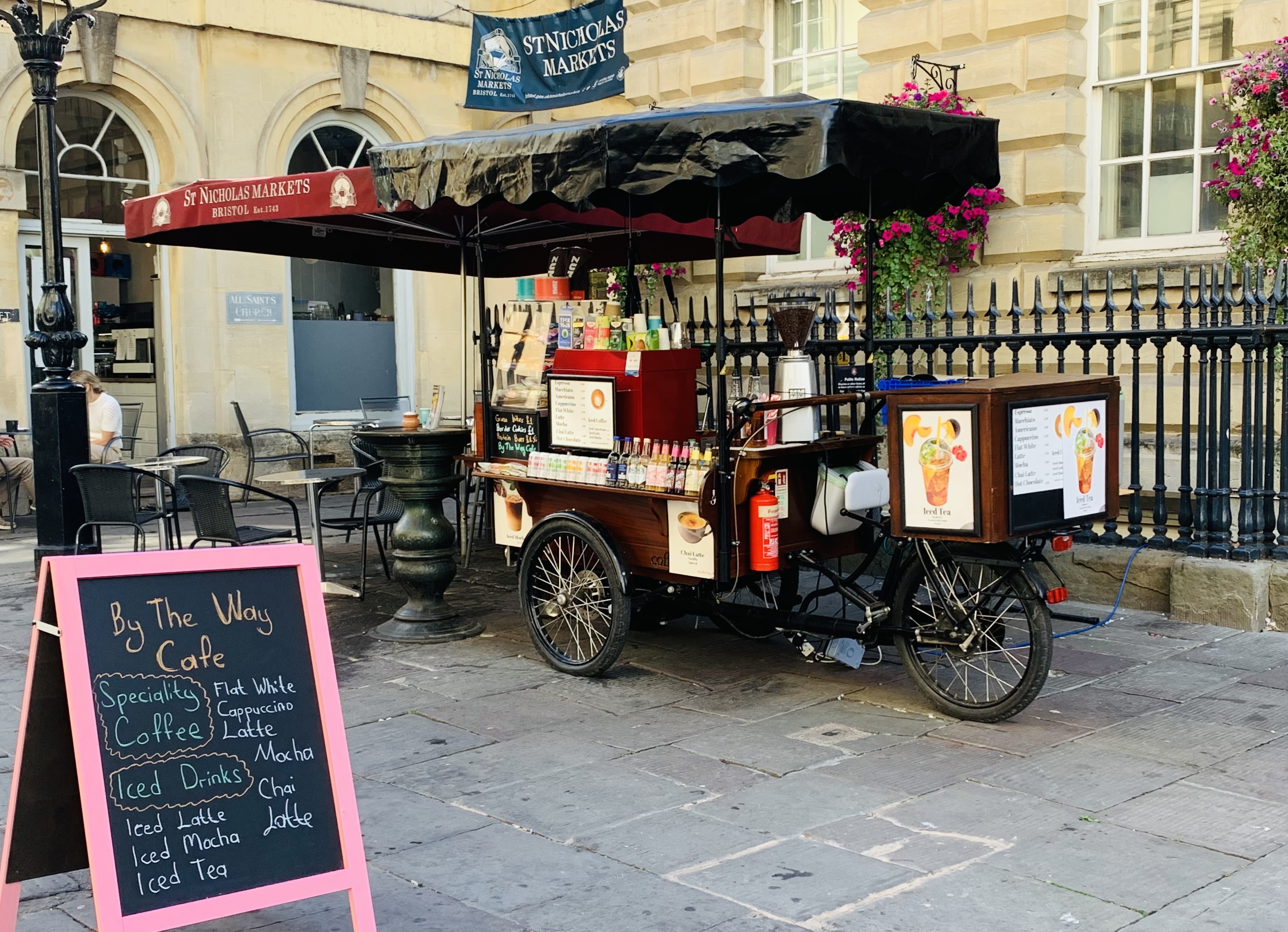 A cafe bike with various drinks and baked goods on it