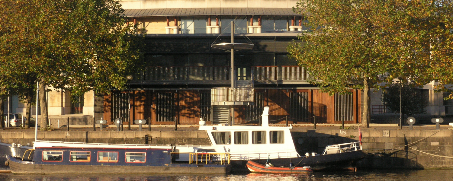 The Harbourside Pavilion from the front on a sunny early evening, with a barge moored in front of it
